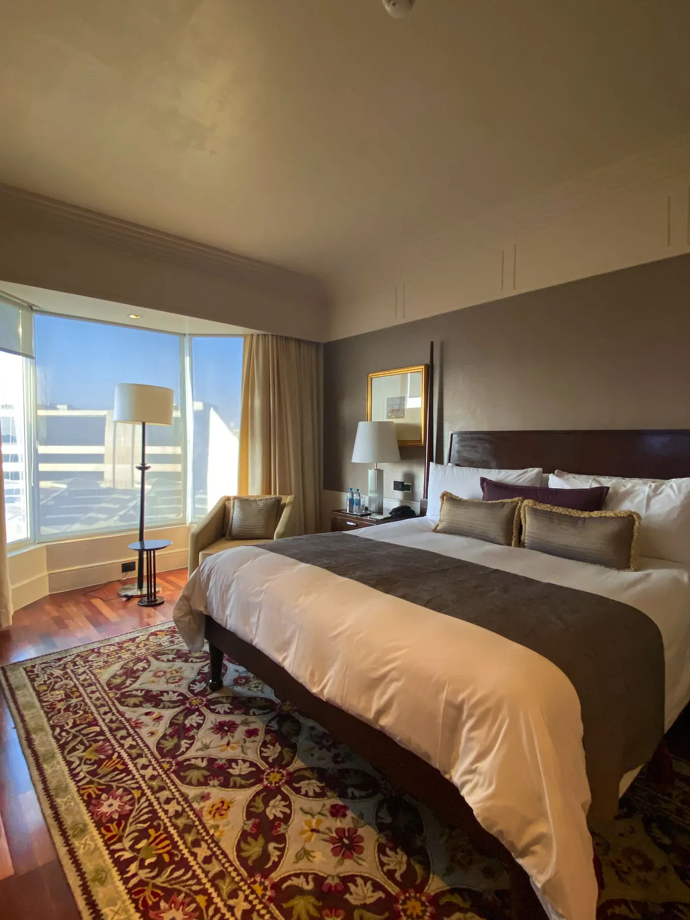 Furnished bedroom with a comfortable bed and a large window