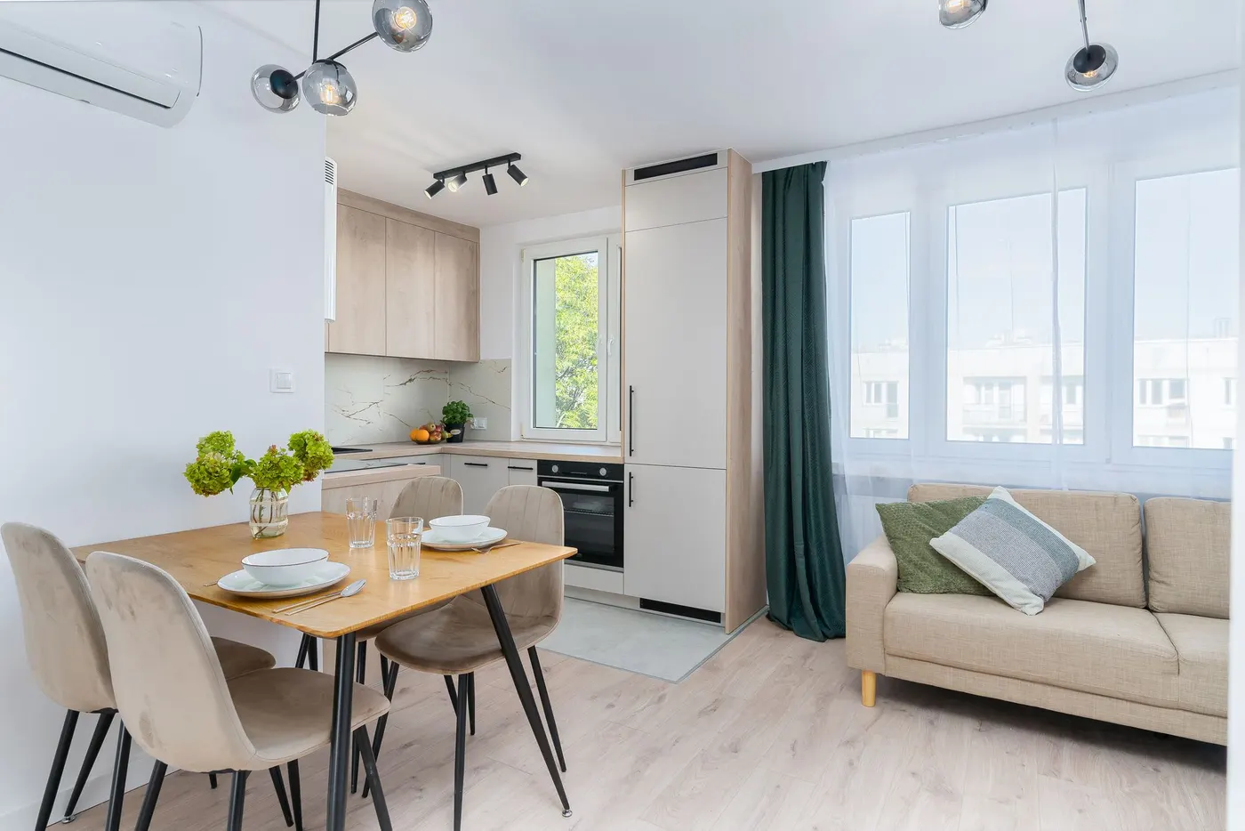 Furnished apartment kitchen and dining area with natural light